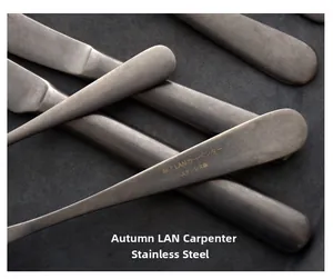 Close-up of vintage matte stainless steel steak knife and cutlery with rustic texture