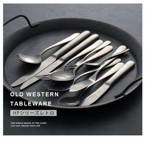 Detail of vintage matte silver stainless steel steak knife and cutlery in a dark aesthetic