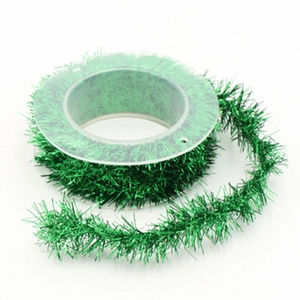 Sparkling green metallic Christmas tinsel ribbon roll for festive gift DIY decoration