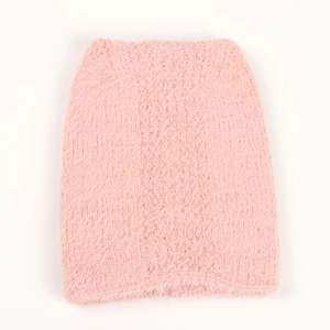Detail of soft pink faux mink fur texture on a warm knitted fox ear winter hat