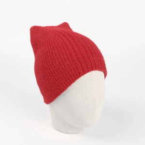 Close-up of red knit beanie with cute fox ears and sparkling gold tinsel textures