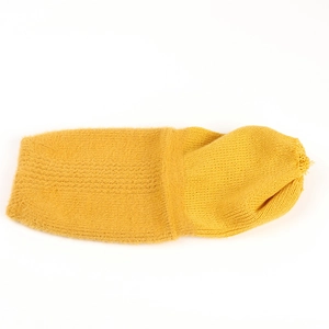 Detailed view of ginger yellow beanie with plush fur and ribbed knit texture