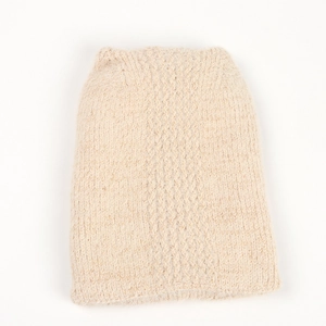 Close-up of the beige cable knit pattern showing soft faux mink texture on the winter hat