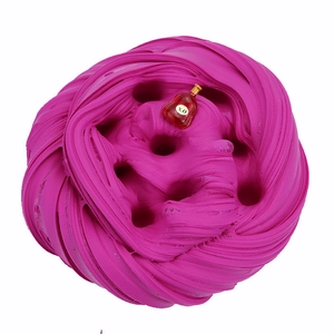 Macro texture of soft magenta butter slime with a miniature X.O bottle accessory