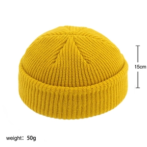 Detail view of yellow ribbed knit beanie showing 15cm height and 50g weight specs