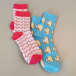 Close-up of rib-knit cuffs and funny cartoon character patterns on novelty socks