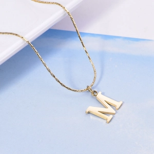 Minimalist gold plated stainless steel necklace featuring a bold M letter pendant