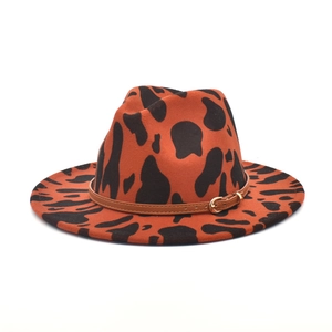 Orange cow print felt fedora hat with wide brim and brown faux leather buckled band