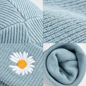 Light blue knit beanie with daisy embroidery, stylish warm winter hat for outdoor wear