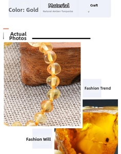 Macro detail of natural golden Baltic amber beads with turquoise accents on wooden stand