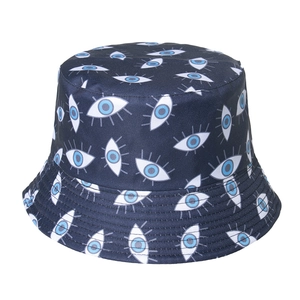 Detail of embroidered evil eye patterns and reinforced stitching on a navy bucket hat