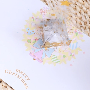 3D pop-up Christmas card featuring a transparent crystal star and pink wreath design