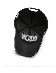 Internal details of black washed denim baseball cap showing stitching and inner lining