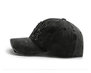 Close-up of distressed washed denim baseball cap with New York 3D embroidery detail