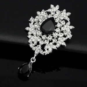 Elegant silver crystal brooch featuring sparkling rhinestones and black teardrop gems