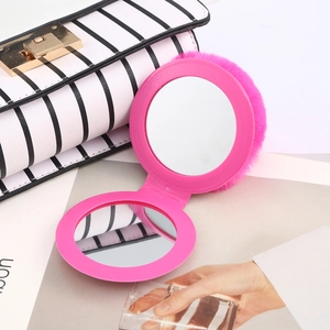 Detail of rose pink faux fur folding makeup mirror with double-sided reflection inside
