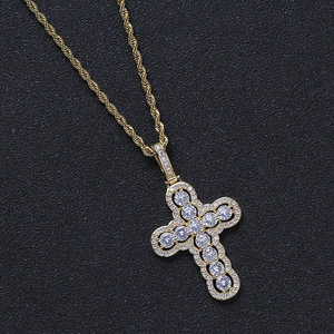 Gold iced out cross pendant with sparkling zircons on a classic rope chain for men