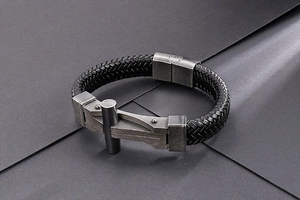 Close-up of black braided leather bracelet with industrial silver-toned metal buckle