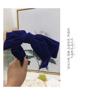Detailed close-up of premium velvet bow headband showing texture and rich blue color