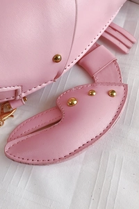Detail of pink PU leather lobster bag with gold rivets and metallic lobster claw shape