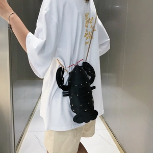 Detailed back view of a black lobster-shaped crossbody bag with gold chain and studs