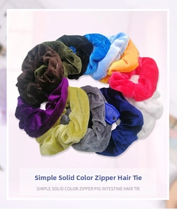 Close-up of velvet scrunchies with hidden zipper pocket holding a blue key inside
