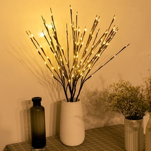 Warm white LED decorative branch lights in a white vase on a checkered tablecloth