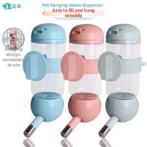 Detail of hanging pet water dispenser showing stainless steel nozzle and secure cage clip