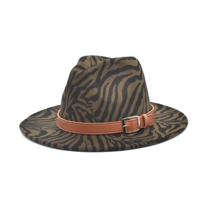 Detailed view of animal print fedora hat with brown leather strap and metal buckle