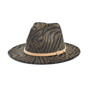 Detail of zebra pattern wool fedora with a slim brown leather strap and gold buckle