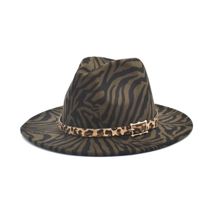 Close-up of zebra print fedora hat featuring leopard pattern band and gold metal buckle