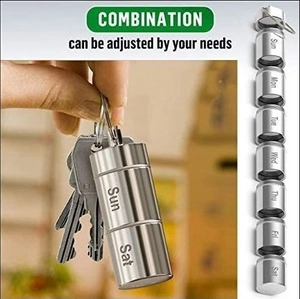 Aluminum pill box with 7 detachable sections and keychain loop shown in usage scene