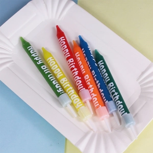 Set of 6 colorful polka dot birthday candles with Happy Birthday text on a paper plate