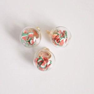 Macro shot of 16mm watermelon glass ball pendants with gold metal caps for jewelry