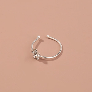 Detailed view of silver nasal ring with sparkling rhinestones and adjustable band