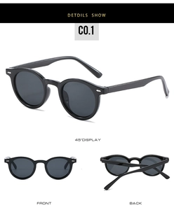 Detail view of round vintage sunglasses with silver rivet accents and dark lenses