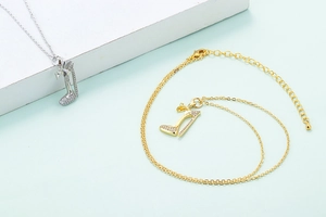Close-up of gold and silver high heel pendant necklaces with micro-pave crystals