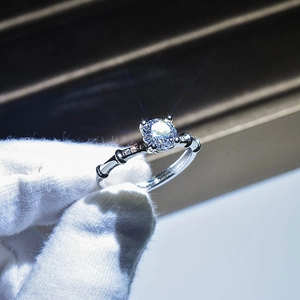 Macro shot of bamboo style silver ring featuring a large round moissanite center stone