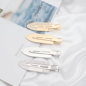 Sparkling rhinestone surfboard hair clips set in gold and silver on silk background