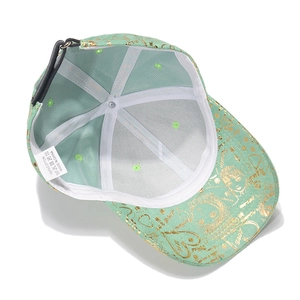 Green cotton floral baseball cap featuring golden graffiti prints and an adjustable strap