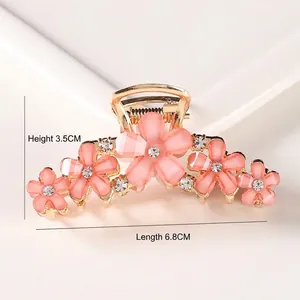 Pink crystal flower hair claw clip with gold alloy finish measuring 6.8cm in length