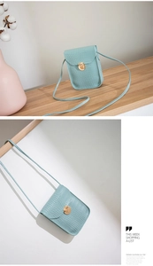 Detail of light blue crocodile embossed phone bag with elegant golden metal buckle clasp