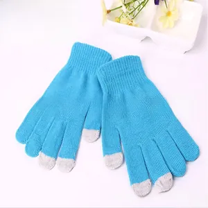 Close-up of thick knit blue touchscreen gloves with gray fingertips for winter warmth