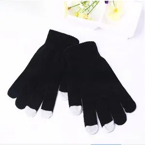 Detail of black winter knit gloves with gray conductive touch screen fingertips