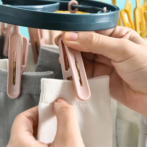 Multi-clip laundry hanger with pink and yellow clips for drying socks and small items