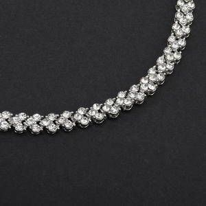 Macro shot of double-row cubic zirconia bracelet with silver claw setting and stones
