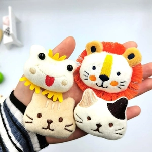 Plush animal badges including lion and cat designs for bag accessories and decorations