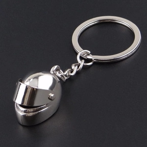 Detailed view of silver metal mini motorcycle helmet keychain with movable visor