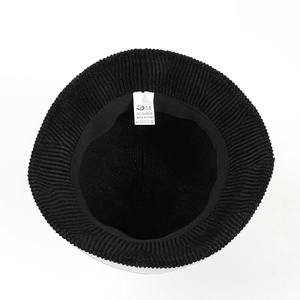 Detailed interior of black chenille bucket hat with high-quality stitching and care label