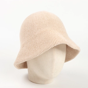 Close-up of beige chenille knit bucket hat featuring thick vertical striped texture